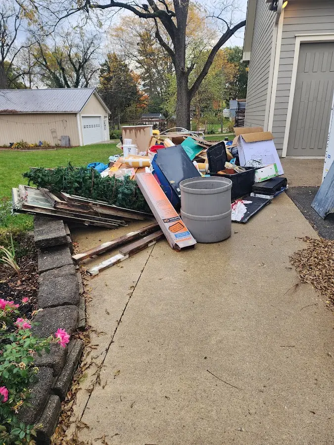 Dumpster being loaded with debris for 10 Yard Dumpster Rental in Waterford